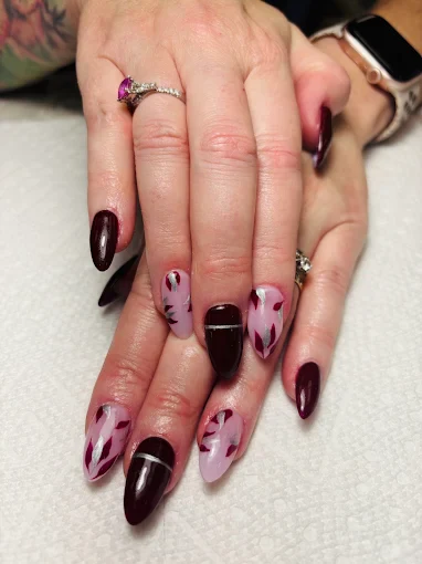 Wine and blush almond nails with painted petal details by Top 10 Nails Spa