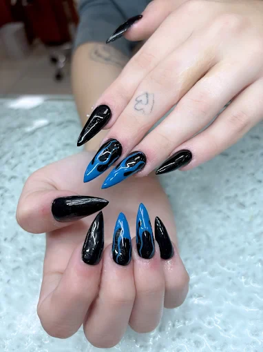 Black and electric blue flame stiletto nails by Top 10 Nails Spa
