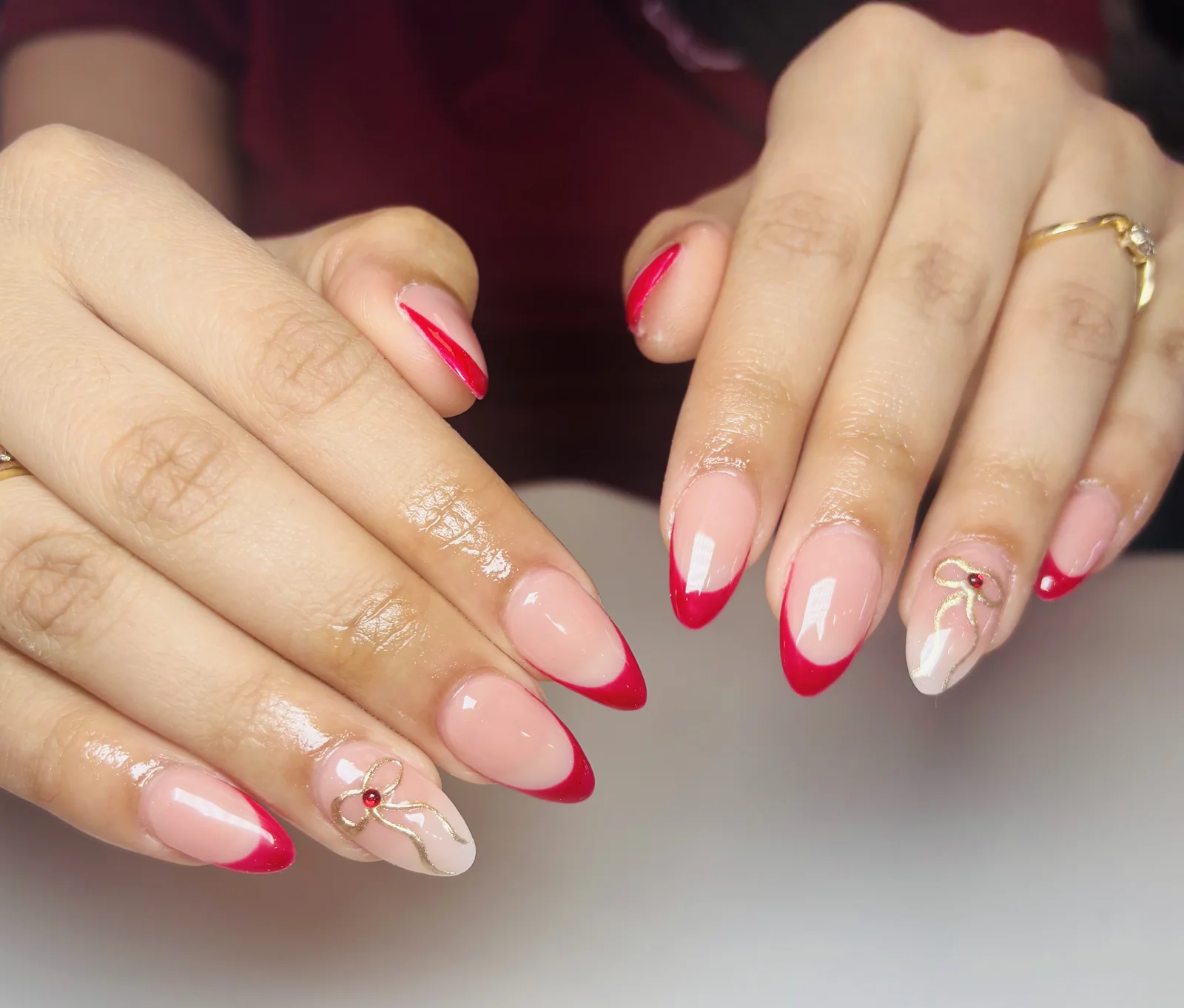 Pink French tips with delicate line art by Top Ten Nails Spa